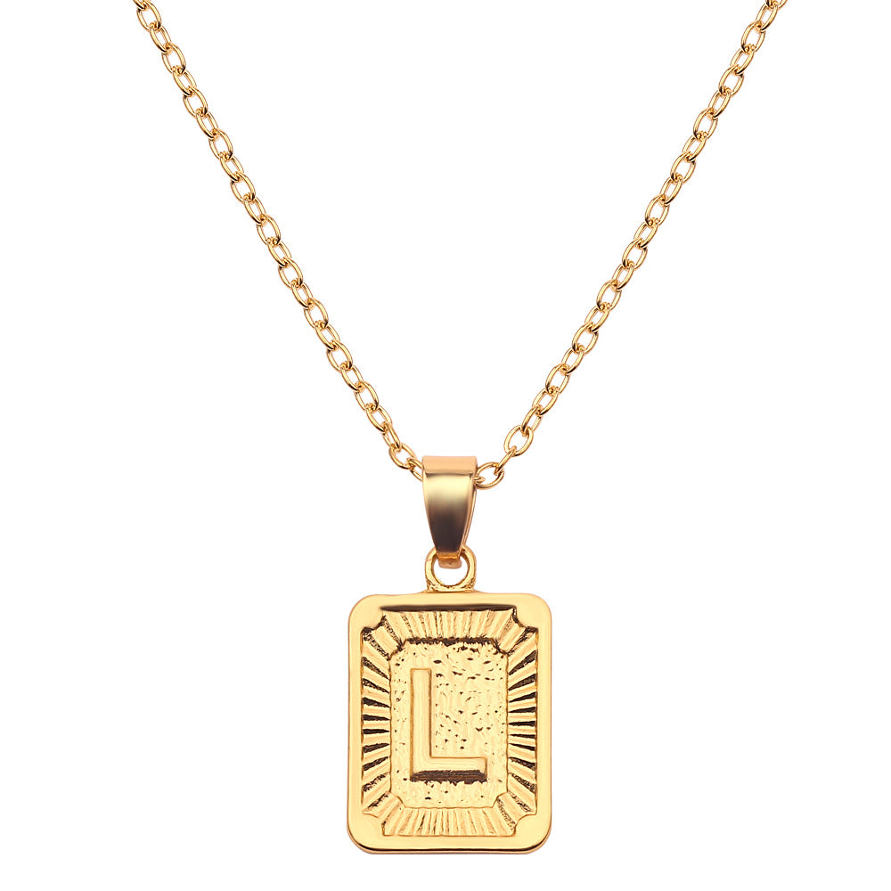 Gold necklace with a rectangular pendant on a white background
