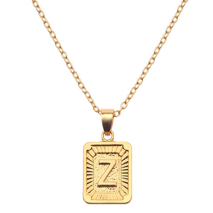 Gold necklace with a rectangular pendant featuring the letter 'Z' on a white background