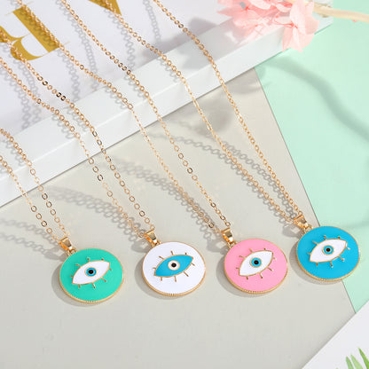 Five necklaces with colorful evil eye pendants on a light background