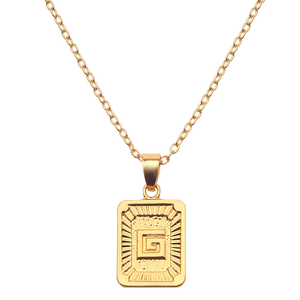 Gold necklace with a rectangular pendant on a white background