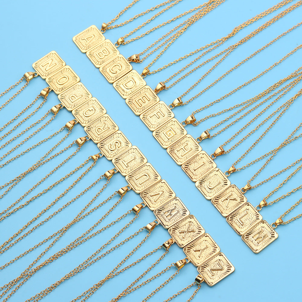 Gold necklaces with letter pendants on a blue background