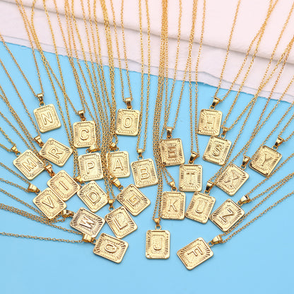 Gold necklaces with letter pendants on a blue background